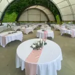Impressive Reception Setting with Flower Arrangement, Tablecloth, and Runner