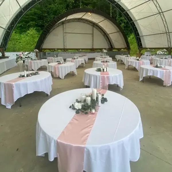 Impressive Reception Setting with Flower Arrangement, Tablecloth, and Runner